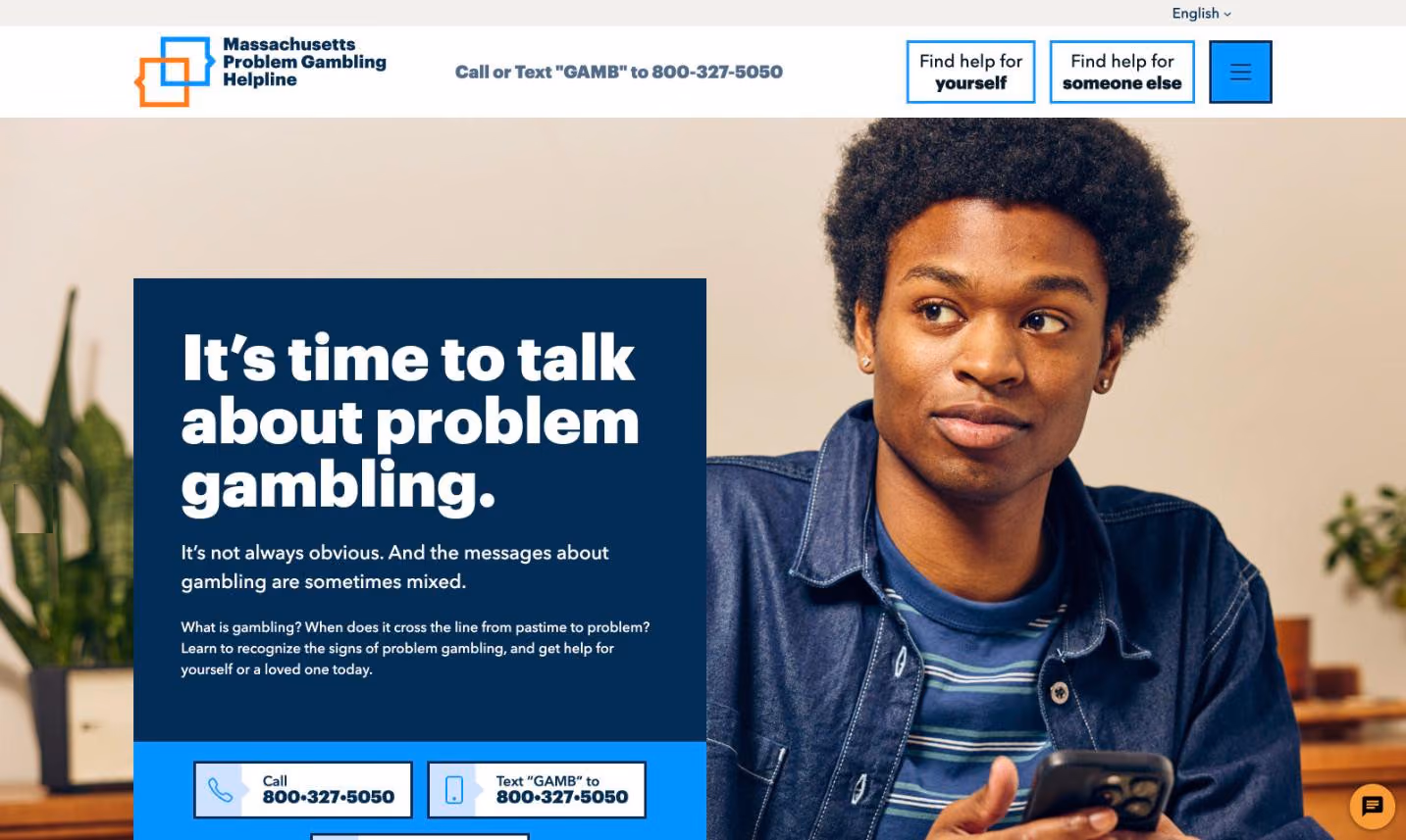 The Massachusetts Problem Gambling Helpline homepage. The header shows “Call or Text ‘GAMB’ to 800-327-5050” beside two menu buttons — “Find help for yourself” and “Find help for someone else” — over a hero reading “It’s time to talk about problem gambling,” with Call and Text buttons repeated below and a live-chat bubble in the corner.