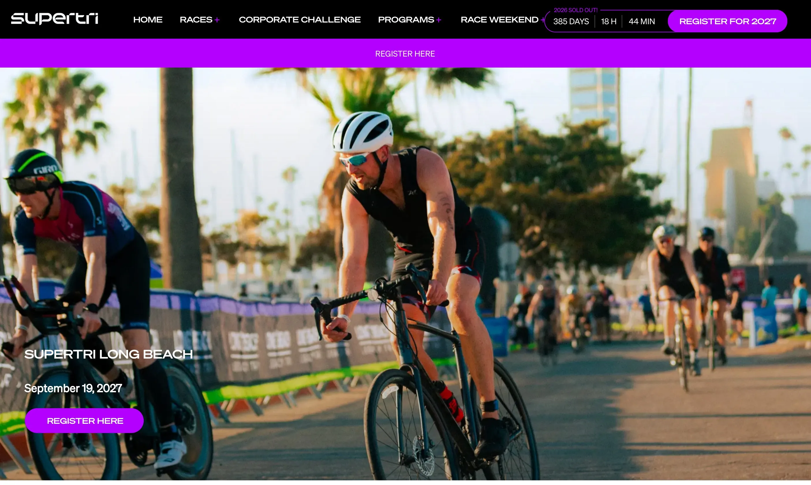 The Supertri Long Beach microsite on supertri.com: its own navigation of Home, Races, Corporate Challenge, Programs and Race Weekend, a “2026 SOLD OUT!” badge with a live countdown beside a Register for 2027 button, and a hero photograph of athletes on the bike leg at the Long Beach race, dated September 19, 2027.