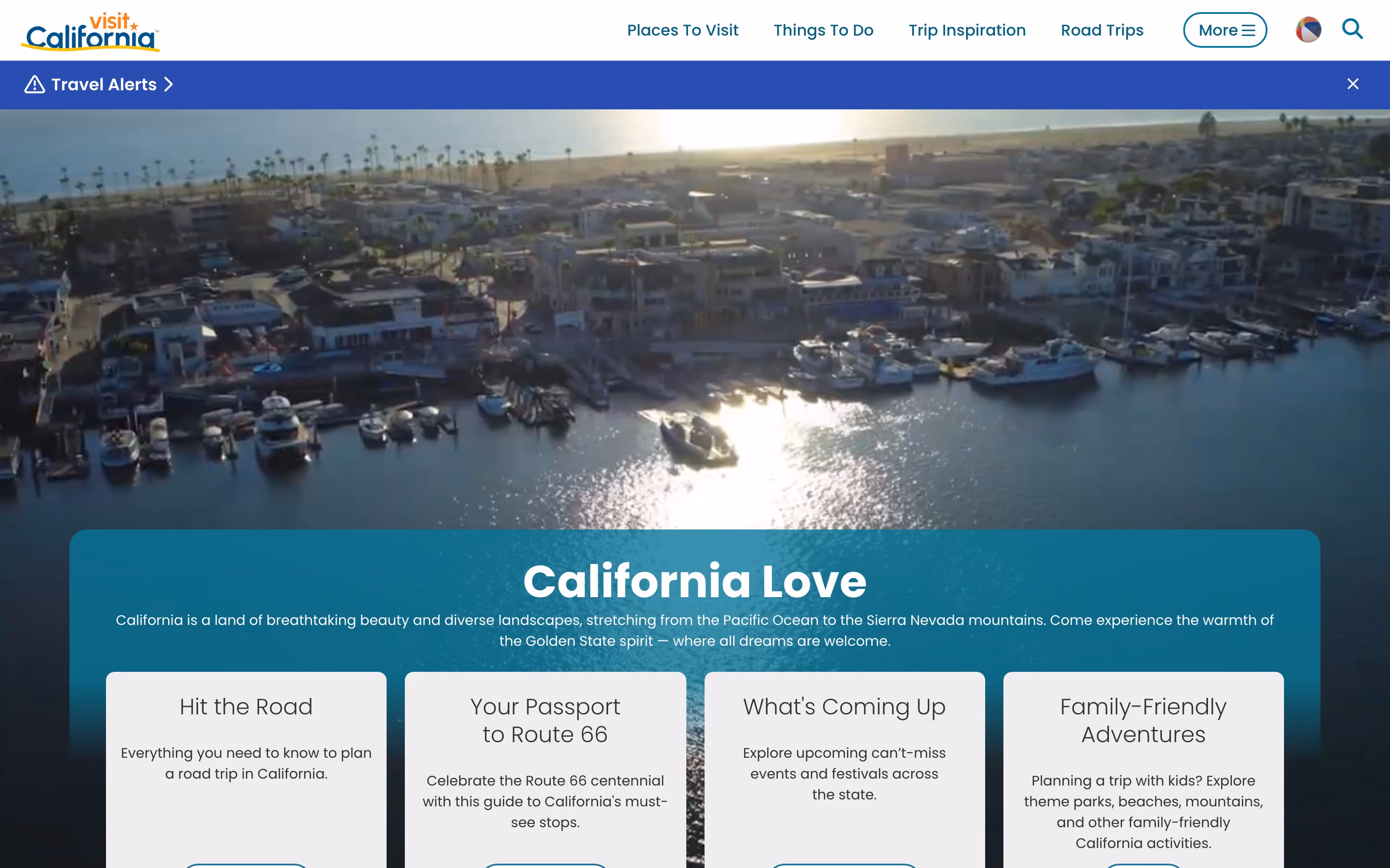 The visitcalifornia.com home page: a full-bleed aerial video of a California harbour at sunset, with a “California Love” panel over it and a row of image-led cards beneath — Hit the Road, Your Passport to Route 66, What’s Coming Up, Family-Friendly Adventures.